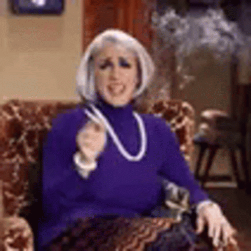 Woman Smoking Cigarette in Purple Sweater and Necklace