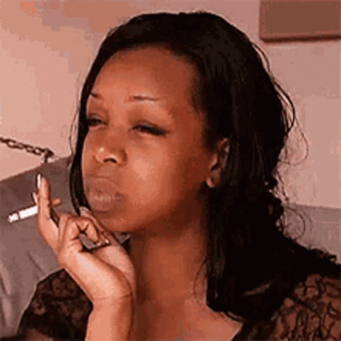 Woman Smoking Cigarette Looking At Phone GIF