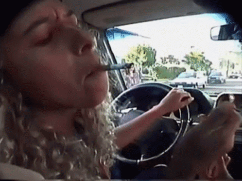 Woman Smoking Cigarette While Driving