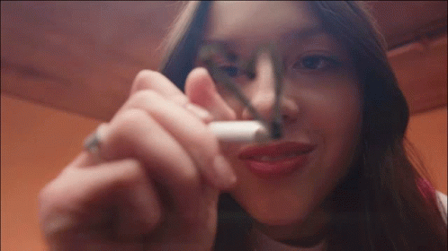 Woman Smoking Cigarette with Marker on Nose