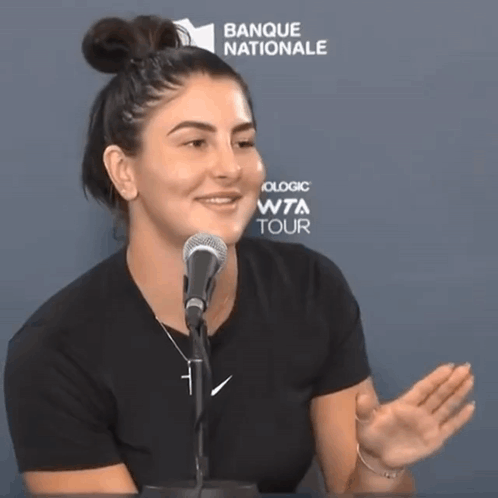 Woman Speaking Into Microphone Banque Nationale Sign