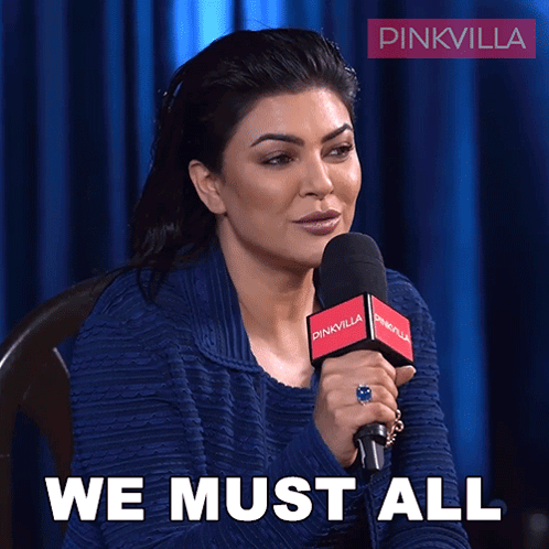 Woman Speaking Into Microphone Saying We Must All