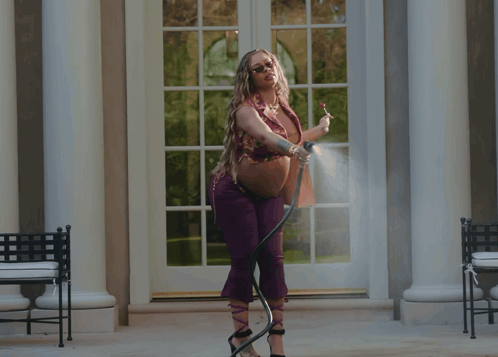 Woman Spraying Water From Hose GIF