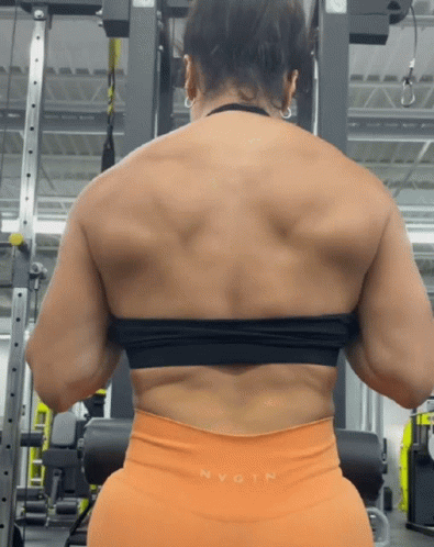 Woman Squatting in Gym Showing Muscles