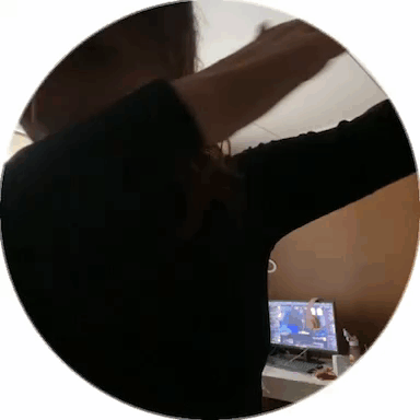 Woman Standing at Computer With Arms Outstretched