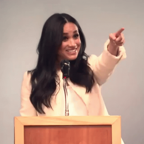 Woman Standing at Podium Pointing