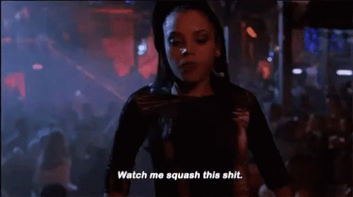 Woman Standing Before Crowd In Dark Room GIF
