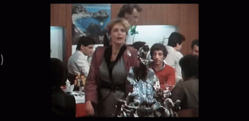 Woman Standing Before Dragon Statue in Crowded Room