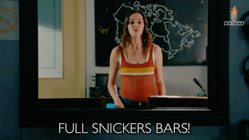 Woman Standing Before Full Snickers Bars