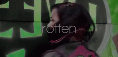 Woman Standing Before Rotten Wall GIF