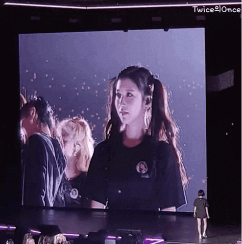 Woman Standing Before Twice Screen GIF