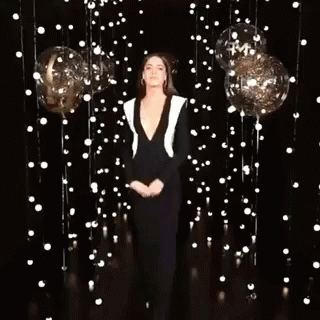Woman Standing by Balloons and Lights