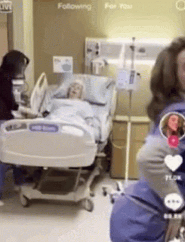 Woman Standing by Hospital Bed