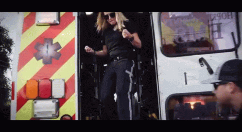 Woman Standing in Ambulance Doorway