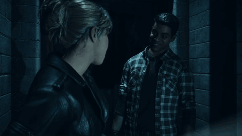 Woman Standing In Dark Room Looking Out Doorway GIF