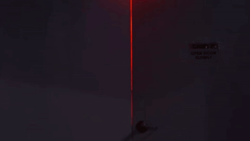Woman Standing in Dark Room with Red Light