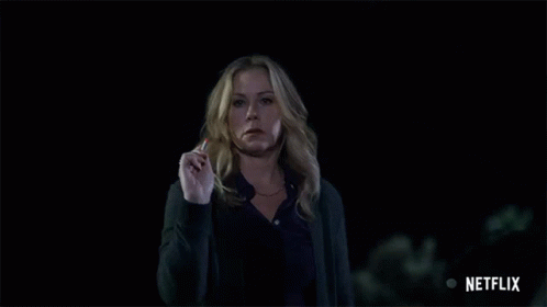 Woman Standing In Dark With Netflix Logo GIF