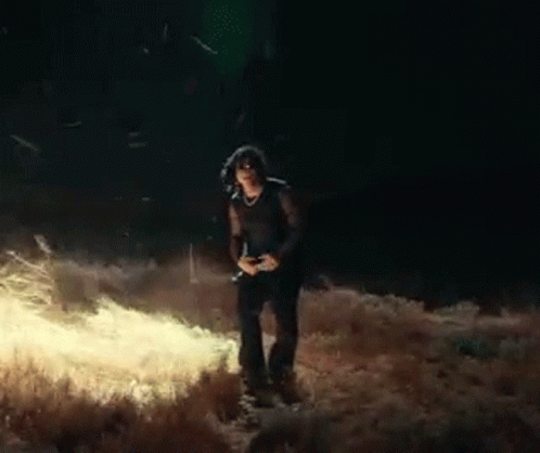 Woman Standing in Field at Night with Camera