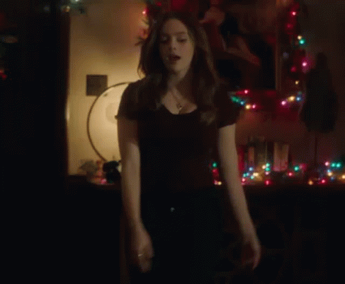Woman Standing in Front of Christmas Tree