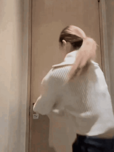 Woman Standing in Front of Door With Number 2