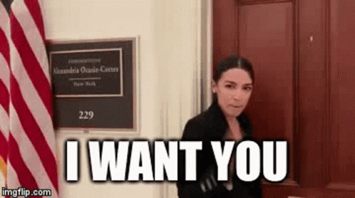 Woman Standing In Front Of Door With Sign Saying I Want You GIF