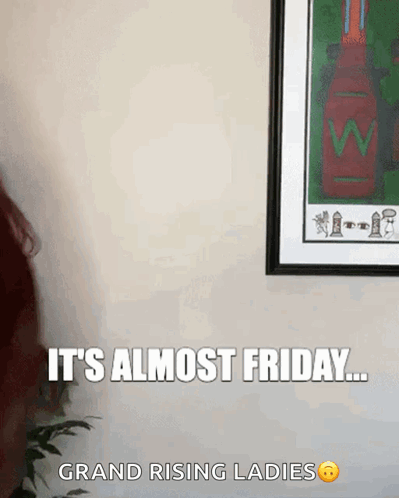 Woman Standing in Front of Framed Picture Saying It's Almost Friday