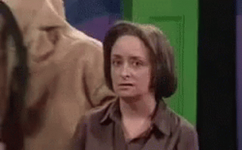 Woman Standing In Front Of Green Door GIF