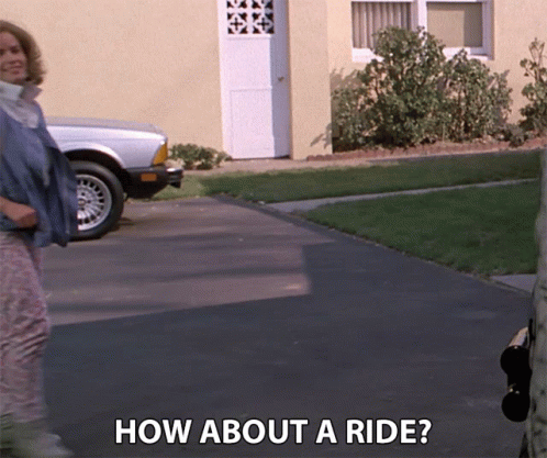 Woman Standing In Front Of House How About A Ride GIF