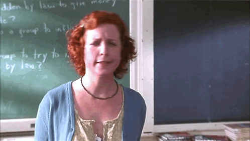 Woman Standing in Front of How to Give Money Chalkboard