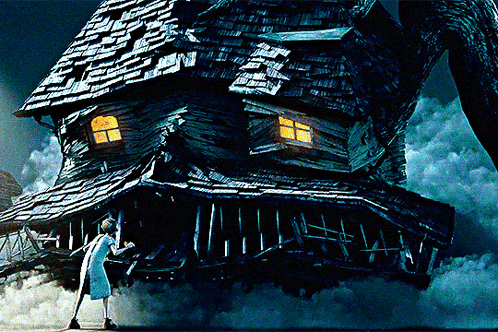 Woman Standing in Front of Large House