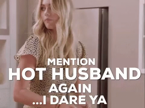 Woman Standing in Front of Refrigerator Saying Mention Hot Husband Again