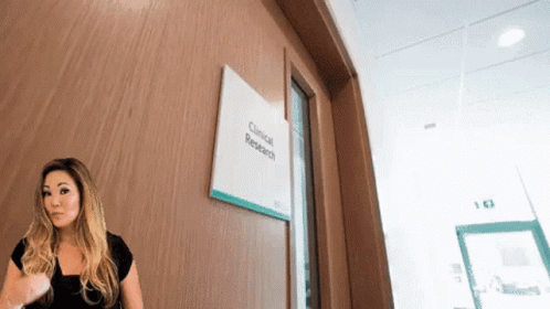 Woman Standing in Front of Research Door