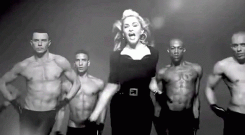 Woman Standing in Front of Shirtless Muscular Men