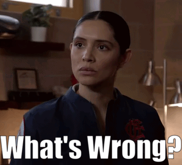 Woman Standing In Front Of Sign Saying What's Wrong GIF