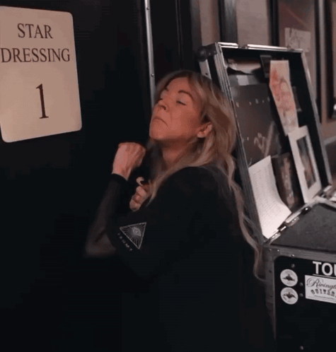 Woman Standing in Front of Star Dressing Sign