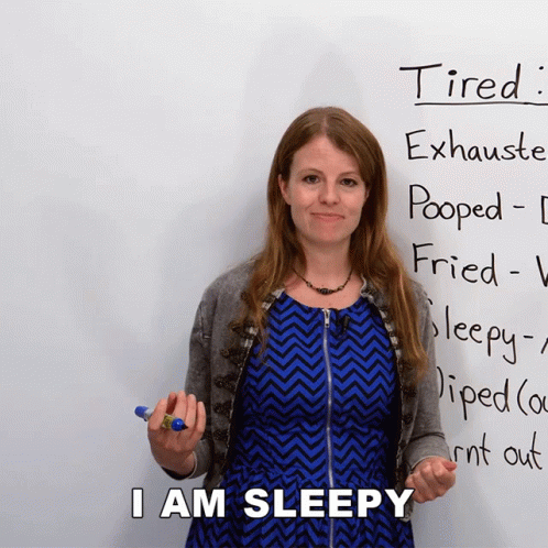Woman Standing in Front of Tired Sign