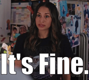 Woman Standing in Front of Wall Saying Its Fine