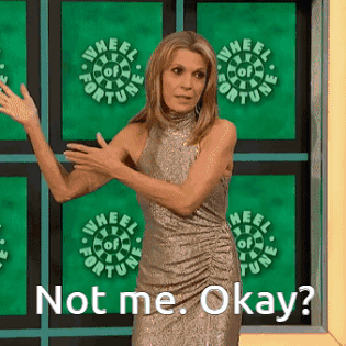 Woman Standing in Front of Wheel of Fortune Sign