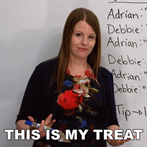 Woman Standing in Front of Whiteboard Saying This Is My Treat