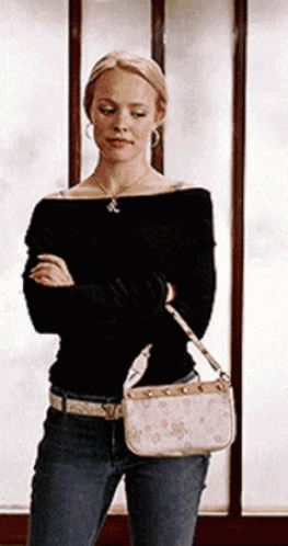 Woman Standing in Front of Window Holding Purse