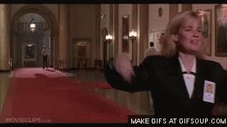 Woman Standing in Hallway Arms Outstretched