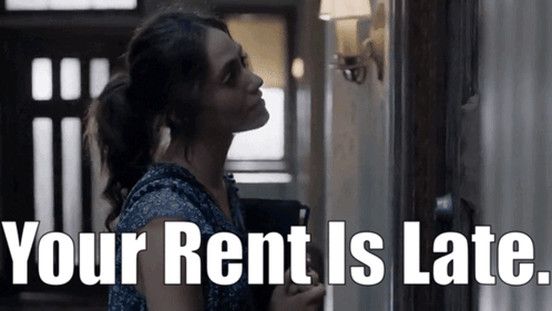 Woman Standing In Hallway With Your Rent Is Late GIF