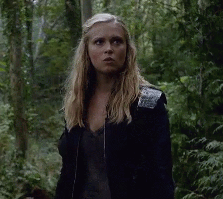 Woman Standing in Woods Wearing Black Jacket