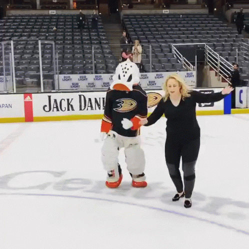 Woman Standing Next To Duck Mascot GIF