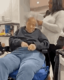 Woman Standing Next To Elderly Man In Wheelchair GIF
