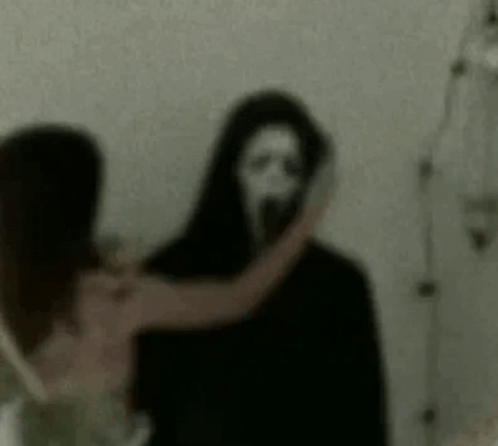 Woman Standing Next to Scary Ghost With Mask