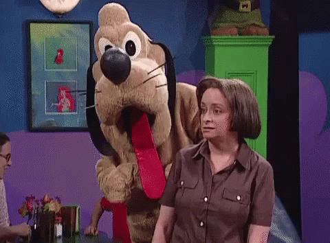 Woman Standing Next To Stuffed Dog With Long Tongue GIF