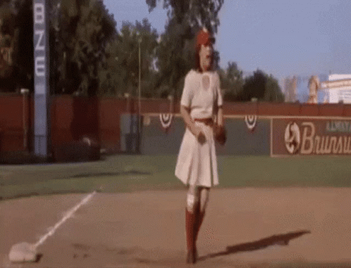 Woman Standing on Baseball Field Holding Baseball