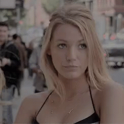 Woman Standing on City Street in Black Top