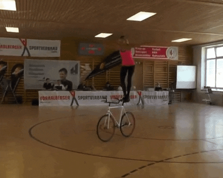Woman Standing On Cycle Trick GIF